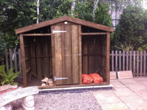 Large log store with central garden toolshed